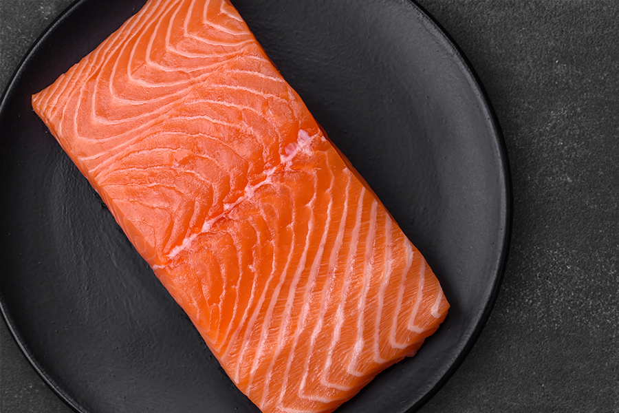 A piece of salmon on a plate.