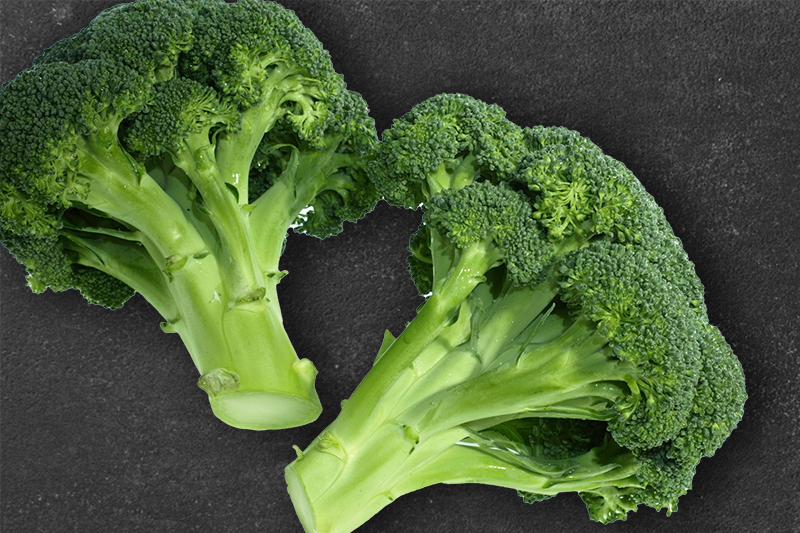 Broccoli florets placed on a black background.