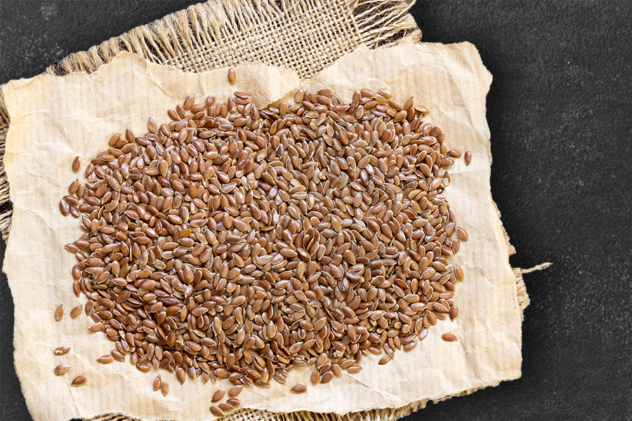 A heap of flaxseeds on a jute cloth