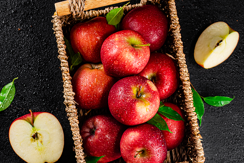 A few red apples in a basket.